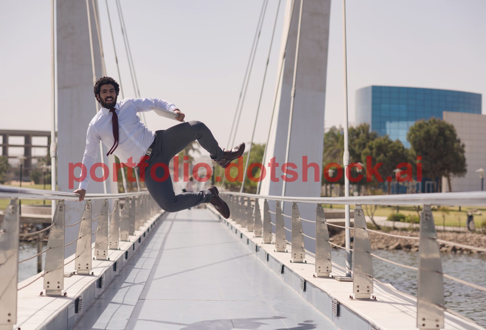 mp70360262-businessman-jumping-on-a-bridge-in-suit-celebrating.jpg
