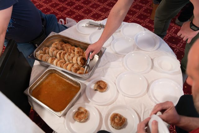 Top view of people serving food at a Mosque a communal meal during Ramadan before breaking the fast on Iftar dinner (16 of 28)