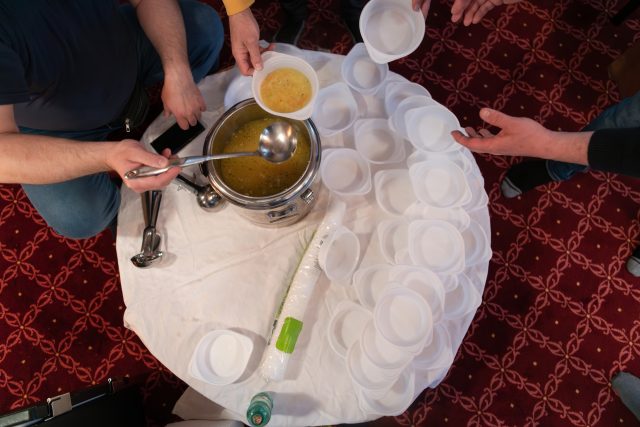 Top view of people serving food at a Mosque a communal meal during Ramadan before breaking the fast on Iftar dinner (5 of 28)