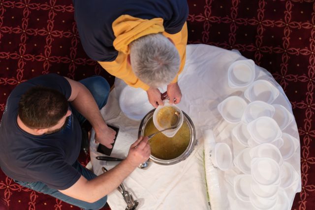 Top view of people serving food at a Mosque a communal meal during Ramadan before breaking the fast on Iftar dinner (11 of 28)