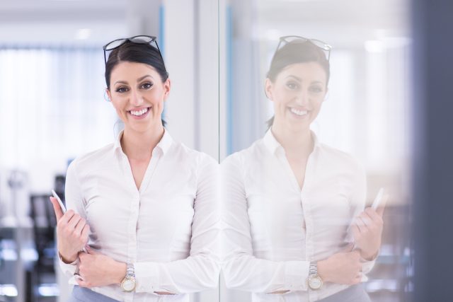 mp22337010-business-woman-using-digital-tablet-in-front-of-startup-office.jpg