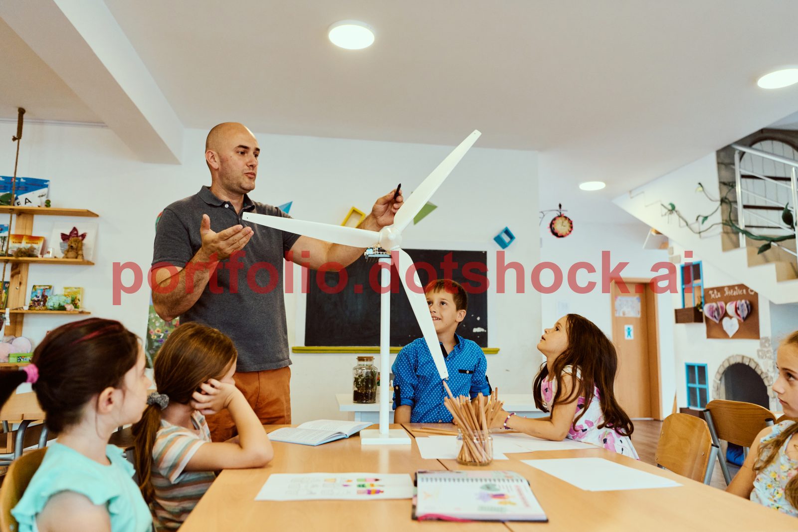 mp70129181-teacher-demonstrates-a-model-wind-turbine-to-engaged.jpg