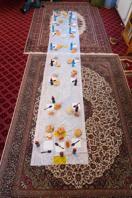 Top view of people serving food at a Mosque a communal meal during Ramadan before breaking the fast on Iftar dinner (2 of 28)