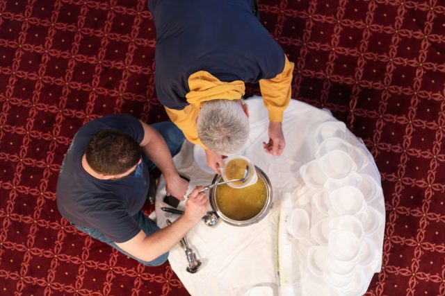 Top view of people serving food at a Mosque a communal meal during Ramadan before breaking the fast on Iftar dinner (8 of 28)
